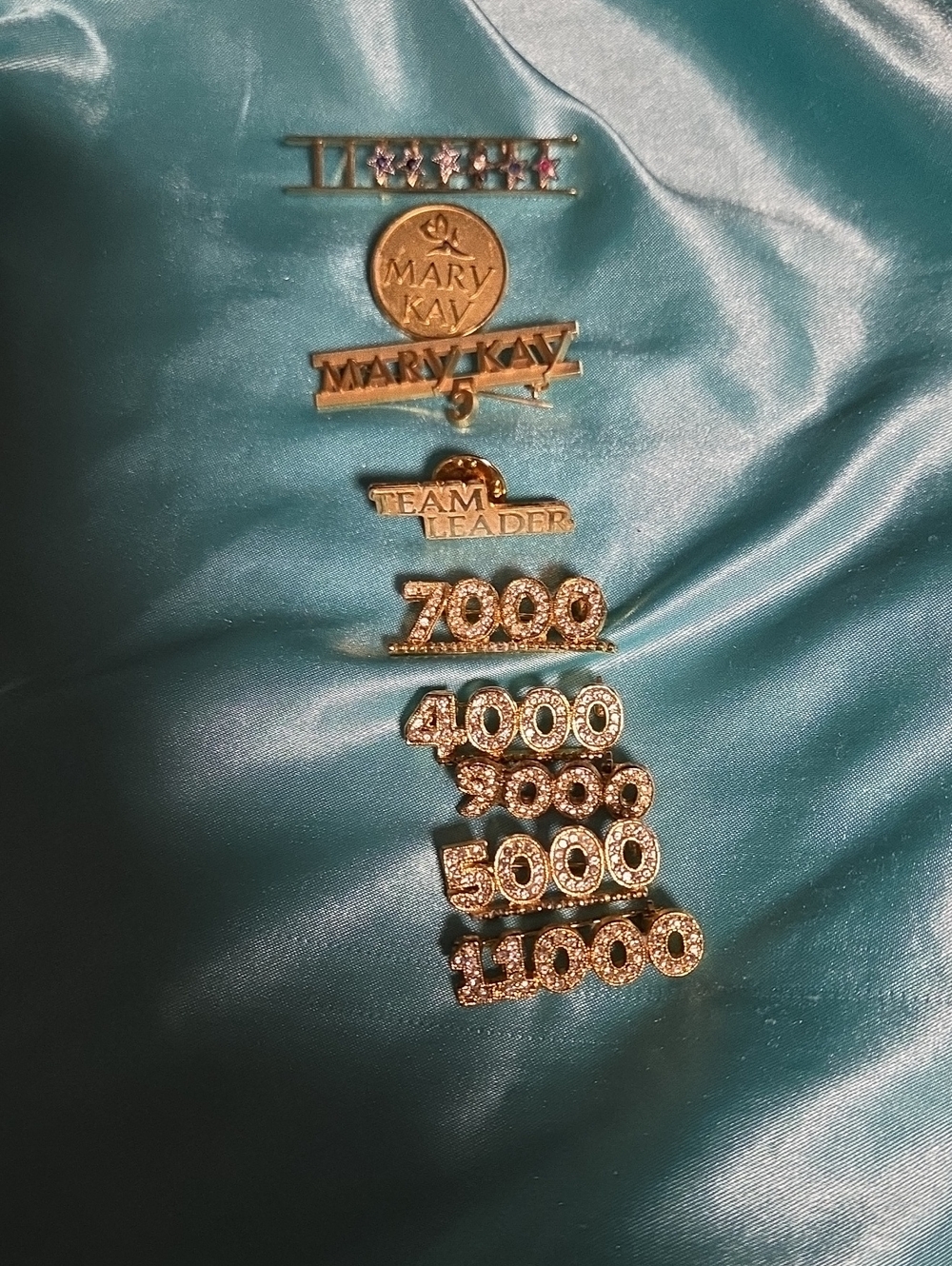 Mary Kay Gold Tone Achievement and Numbered Rhinestone Pins on Teal